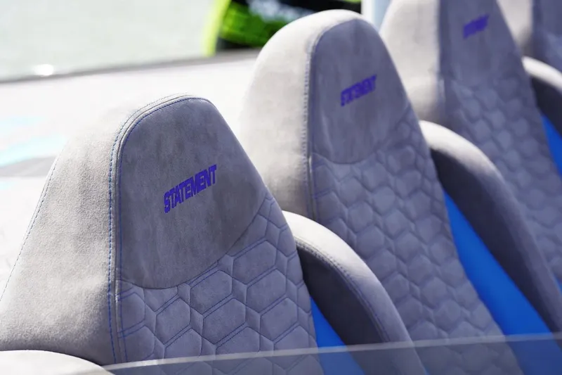 Slide: The Image of Manufacturer Provided Image: Luxurious seats in the 2026 Statement 360 CAT with hexagonal pattern and blue stitching. - 7