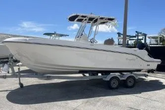 Slide: The Image of 2023 Trophy T24 CC boat on trailer under clear blue sky. - 5