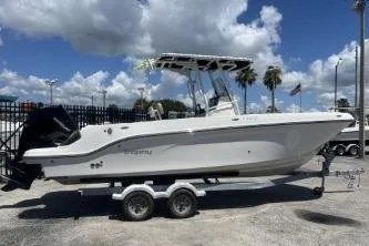 The Image of 2023 Trophy T24 CC boat on trailer under blue sky with clouds. - 1