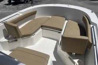 Slide: The Image of 2023 Trophy T24 CC boat interior with beige seating and spacious layout. - 9