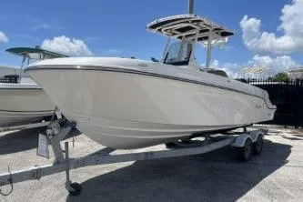 Slide: The Image of 2023 Trophy T24 CC boat on trailer under clear blue sky. - 4