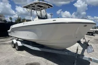 Slide: The Image of 2023 Trophy T24 CC boat on trailer under a cloudy sky. - 2