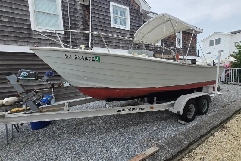 Slide: The Image of 1974 Chris-Craft 22 Tournament Fisherman boat on trailer, parked beside a house. - 5