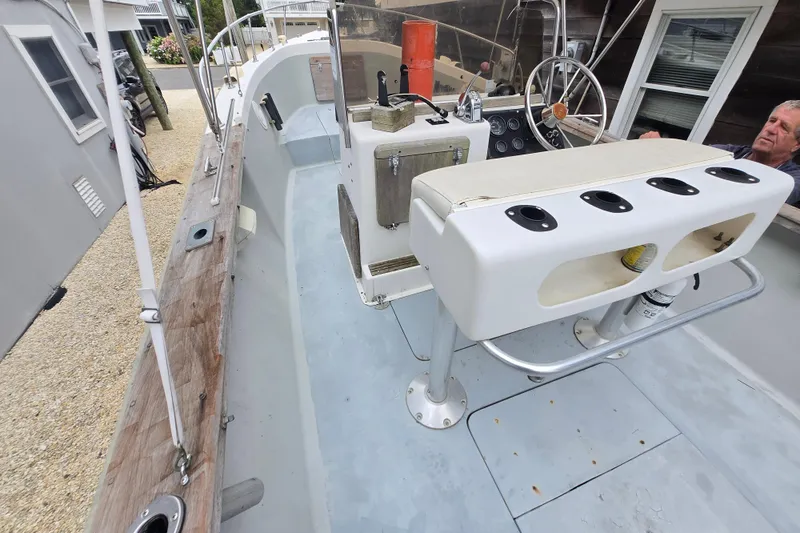 Slide: The Image of 1974 Chris-Craft 22 Tournament Fisherman boat interior with steering wheel and seating. - 22
