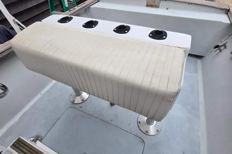 Slide: The Image of 1974 Chris-Craft 22 Tournament Fisherman boat seat with rod holders, white upholstery. - 17