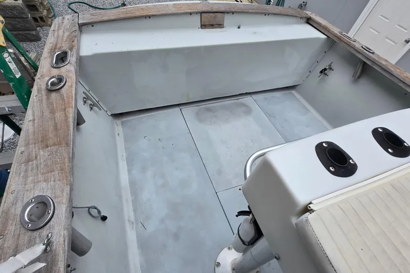 Slide: The Image of 1974 Chris-Craft 22 Tournament Fisherman boat interior with wooden trim and fishing rod holders. - 3