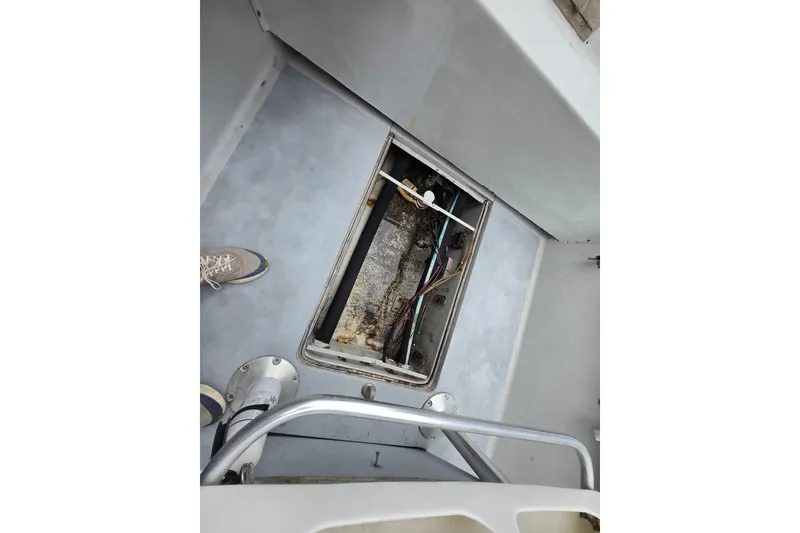 Slide: The Image of 1974 Chris-Craft 22 Tournament Fisherman boat interior with open hatch and visible wiring. - 11