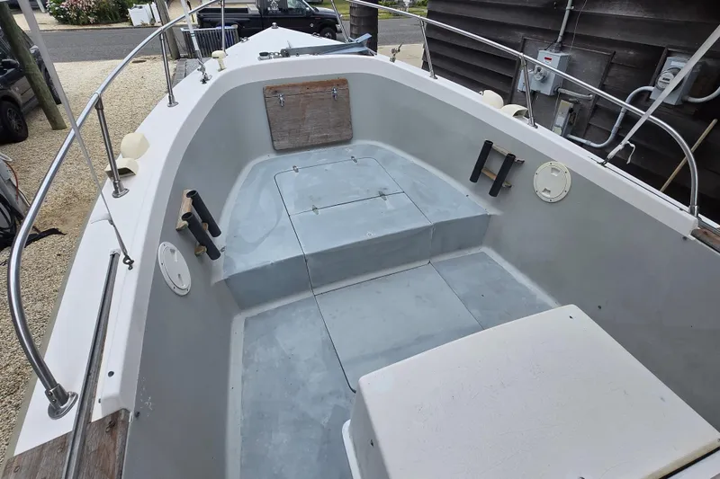 Slide: The Image of 1974 Chris-Craft 22 Tournament Fisherman boat interior with seating and storage compartments. - 4