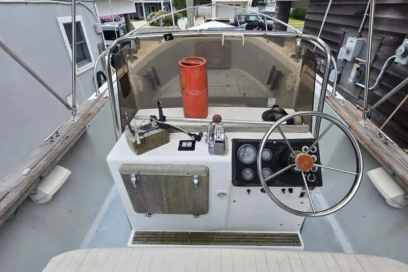 Slide: The Image of 1974 Chris-Craft 22 Tournament Fisherman boat cockpit with steering wheel and control panel. - 15