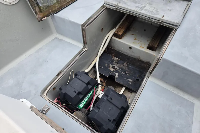Slide: The Image of 1974 Chris-Craft 22 Tournament Fisherman boat battery compartment with wiring and storage. - 26