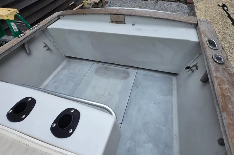 Slide: The Image of 1974 Chris-Craft 22 Tournament Fisherman boat interior with wooden trim and rod holders. - 18