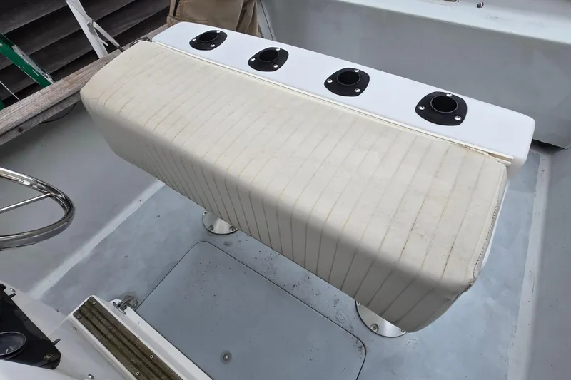 Slide: The Image of 1974 Chris-Craft 22 Tournament Fisherman boat seat with rod holders on deck. - 14