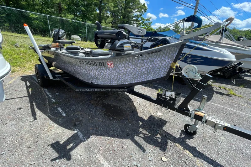 Slide: The Image of 2018 StealthCraft 16 Power Drifter boat on trailer, parked outdoors under blue sky. - 8
