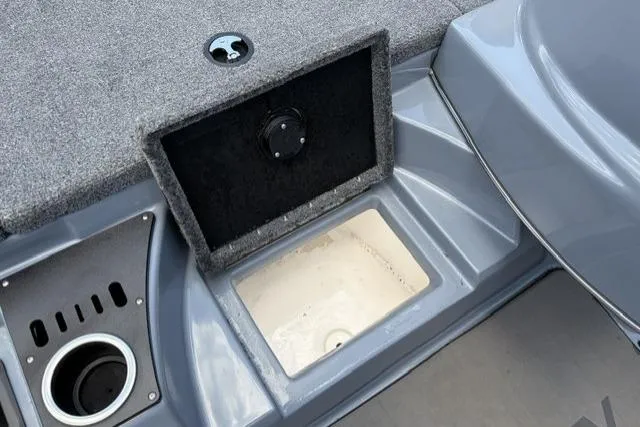Slide: The Image of 2025 Falcon Boats F-18 interior storage compartment with cup holder and gray finish. - 5