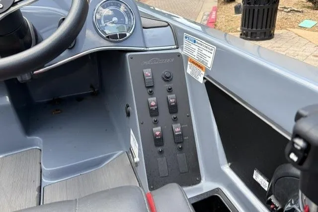 Slide: The Image of Control panel of 2025 Falcon Boats F-18, featuring switches and gauges. - 14