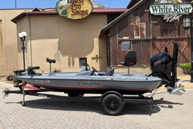 Slide: The Image of 2025 Falcon Boats F-18 on trailer outside Bass Pro Shops, featuring sleek design and modern equipment. - 1