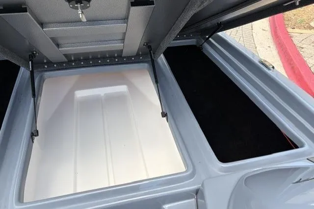 Slide: The Image of Open storage compartments of a 2025 Falcon Boats F-18, showcasing interior space. - 7