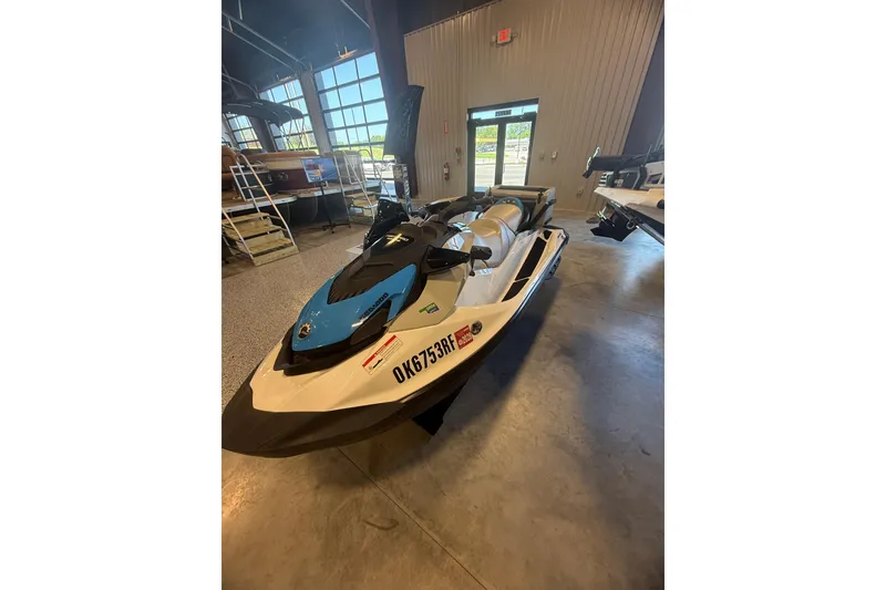 Slide: The Image of 2022 Seadoo FishPro jet ski in showroom, featuring sleek design and blue accents. - 5