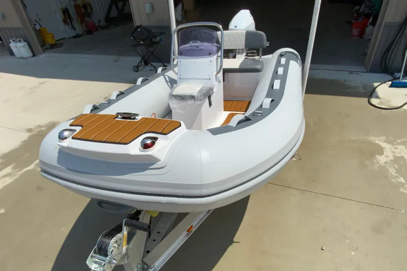 Slide: The Image of 2027 Gala A330L inflatable boat on trailer, featuring sleek design and modern amenities. - 4