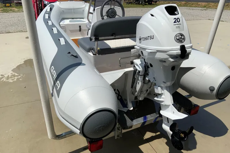 The Image of Inflatable boat Gala A330L 2027 with Tohatsu outboard motor on a concrete surface. - 1