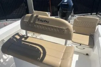 Slide: The Image of 2022 Trophy T20 boat interior with beige seating and motor in background. - 12