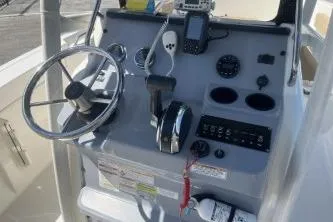 Slide: The Image of 2022 Trophy T20 boat dashboard with steering wheel, controls, and navigation equipment. - 9