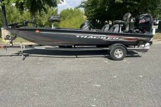 The Image of 2019 Tracker Pro Team 190 TX boat on trailer, parked outdoors. - 1