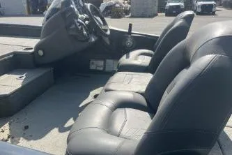 Slide: The Image of 2019 Tracker Pro Team 190 TX boat interior with three seats and steering console. - 6