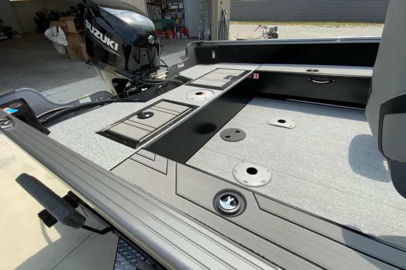 Slide: The Image of 2026 Starcraft Storm 166 DC boat interior with Suzuki motor, featuring storage compartments and seating area. - 8
