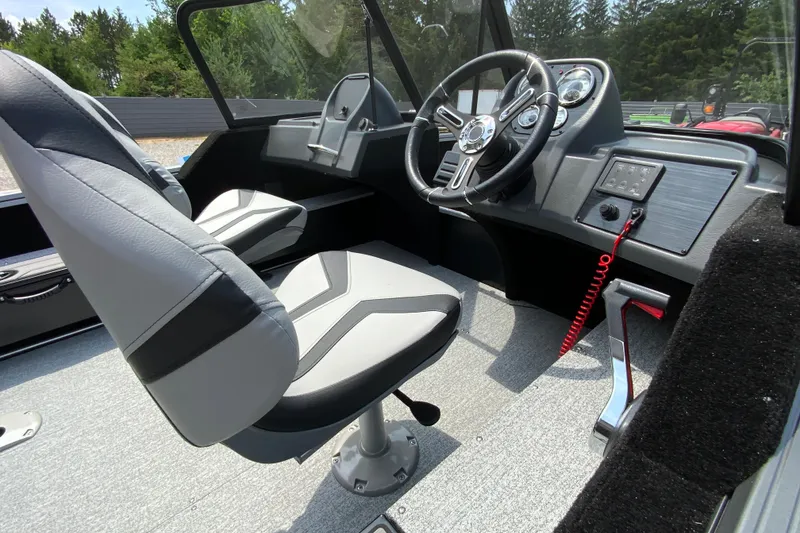 Slide: The Image of 2026 Starcraft Storm 166 DC boat interior with modern steering console and comfortable seating. - 6