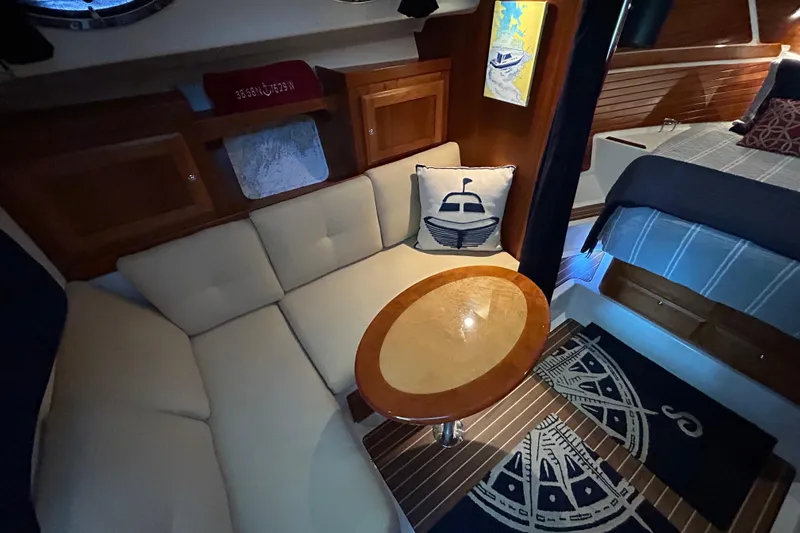Slide: The Image of Interior of a 2016 Back Cove 34 boat with cozy seating and nautical decor. - 55