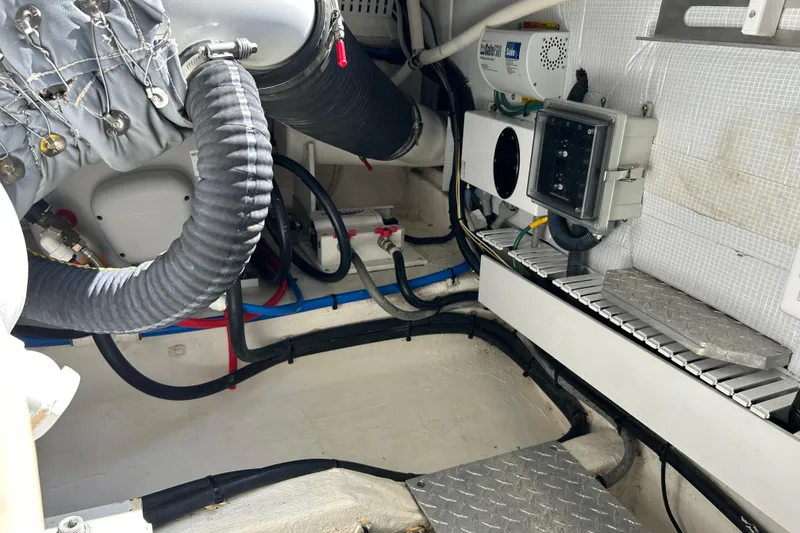 Slide: The Image of Engine room of a 2016 Back Cove 34 boat, showcasing mechanical components and wiring. - 29