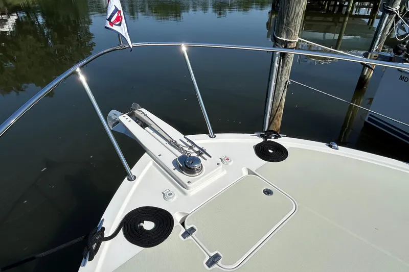 Slide: The Image of Bow of 2016 Back Cove 34 boat with anchor and railing in marina. - 12