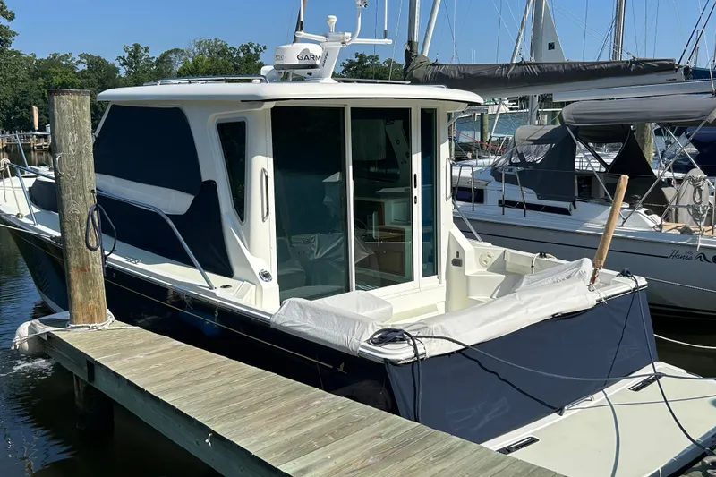 Slide: The Image of 2016 Back Cove 34 boat docked at marina, featuring sleek design and modern amenities. - 3