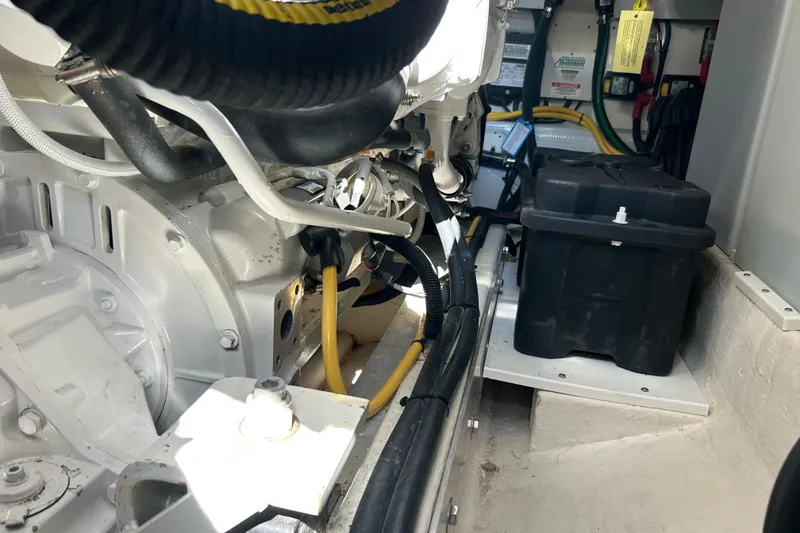 Slide: The Image of Engine compartment of a 2016 Back Cove 34 boat, featuring cables and battery box. - 34