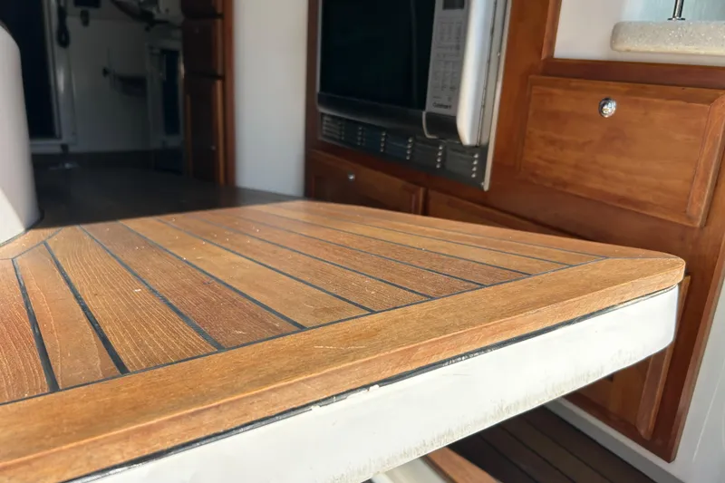 Slide: The Image of Interior of 2016 Back Cove 34 boat with wooden table and cabinetry. - 20