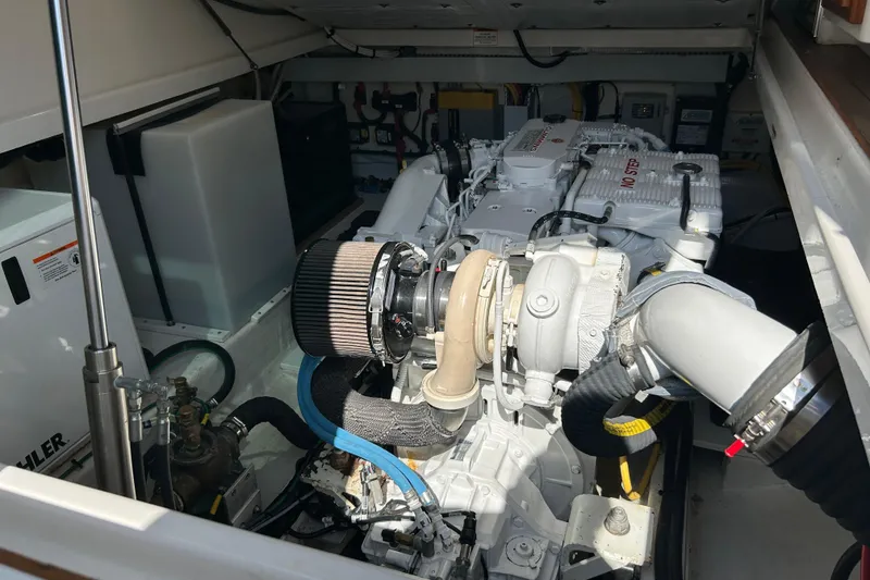 Slide: The Image of Engine compartment of a 2016 Back Cove 34 boat, showcasing detailed mechanical components. - 22