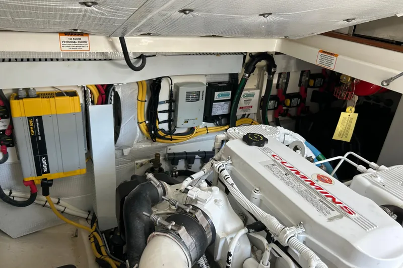 Slide: The Image of Engine room of a 2016 Back Cove 34 boat featuring Cummins engine and electrical components. - 26