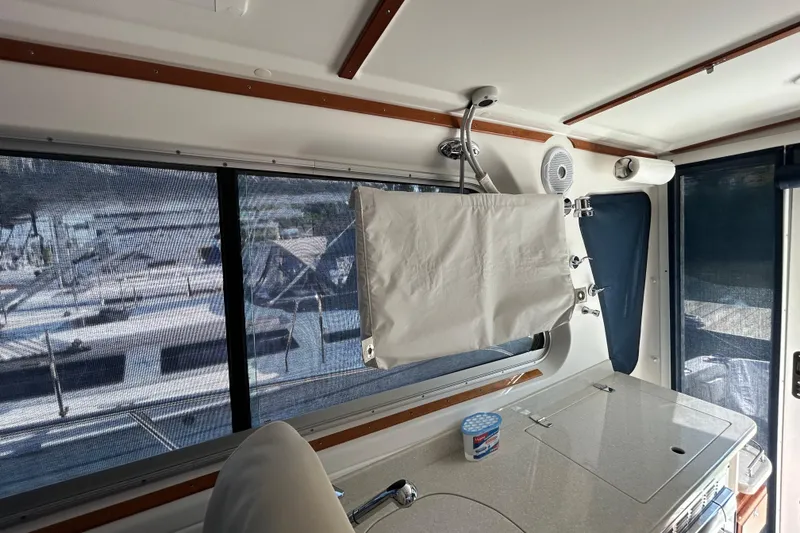 Slide: The Image of Interior view of a 2016 Back Cove 34 boat with a kitchenette and window. - 39