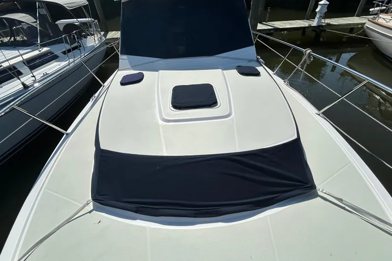 Slide: The Image of 2016 Back Cove 34 yacht deck with sun pads and railing in marina. - 9