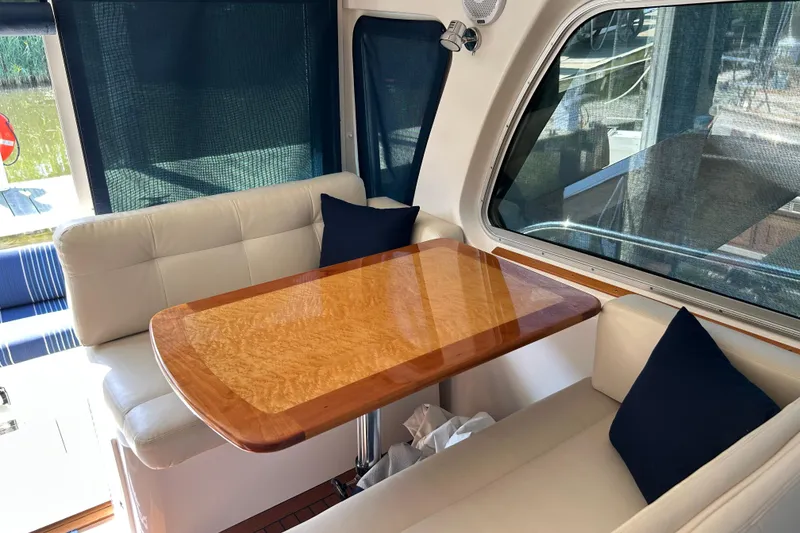 Slide: The Image of Interior of 2016 Back Cove 34 yacht with elegant wooden table and cushioned seating. - 36
