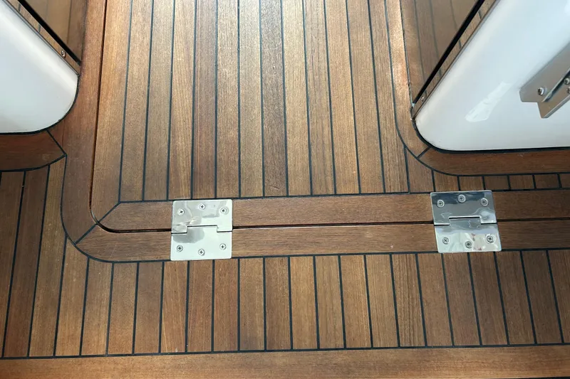 Slide: The Image of Teak deck flooring with metal hinges on a 2016 Back Cove 34 boat. - 21