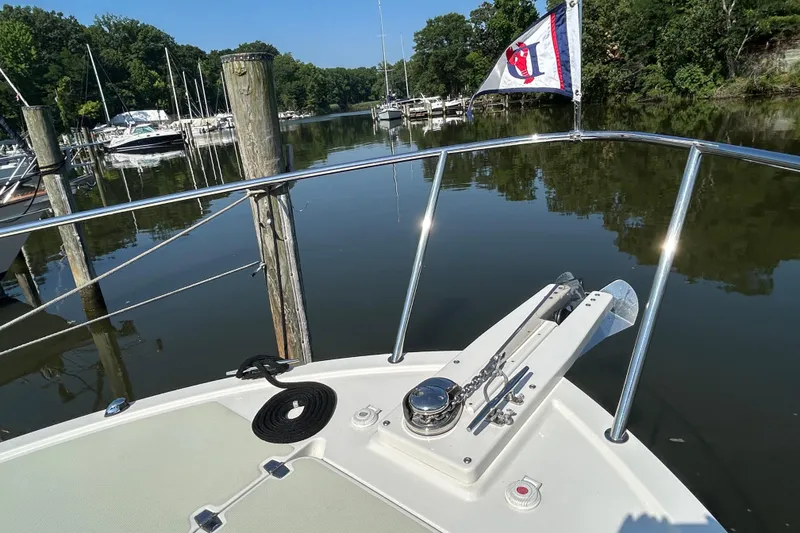 Slide: The Image of Bow view of 2016 Back Cove 34 boat docked in a serene marina setting. - 15