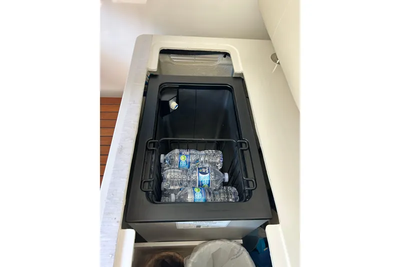 Slide: The Image of Built-in cooler with water bottles on a 2016 Back Cove 34 boat. - 40
