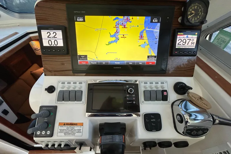 Slide: The Image of Helm of 2016 Back Cove 34 boat with Garmin navigation system and controls. - 43