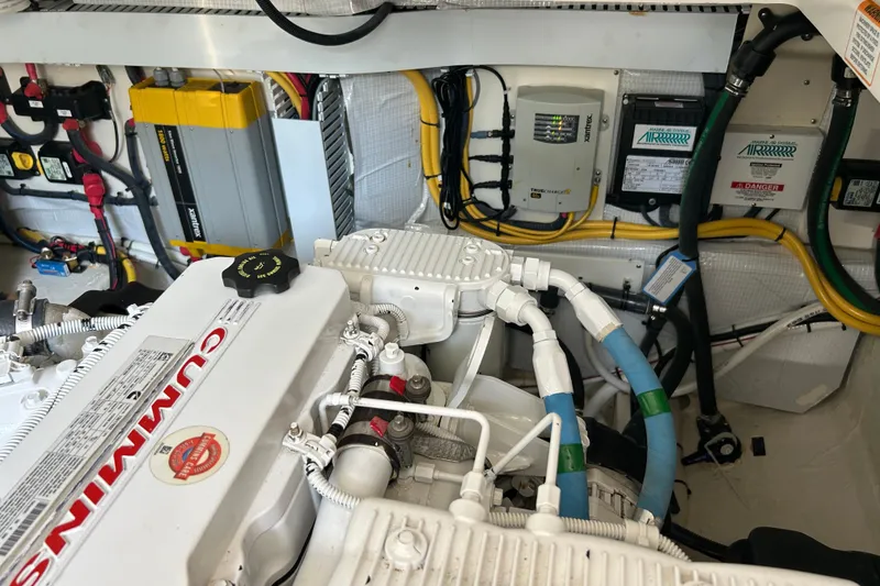 Slide: The Image of Engine room of a 2016 Back Cove 34 boat featuring a Cummins engine and electrical components. - 23