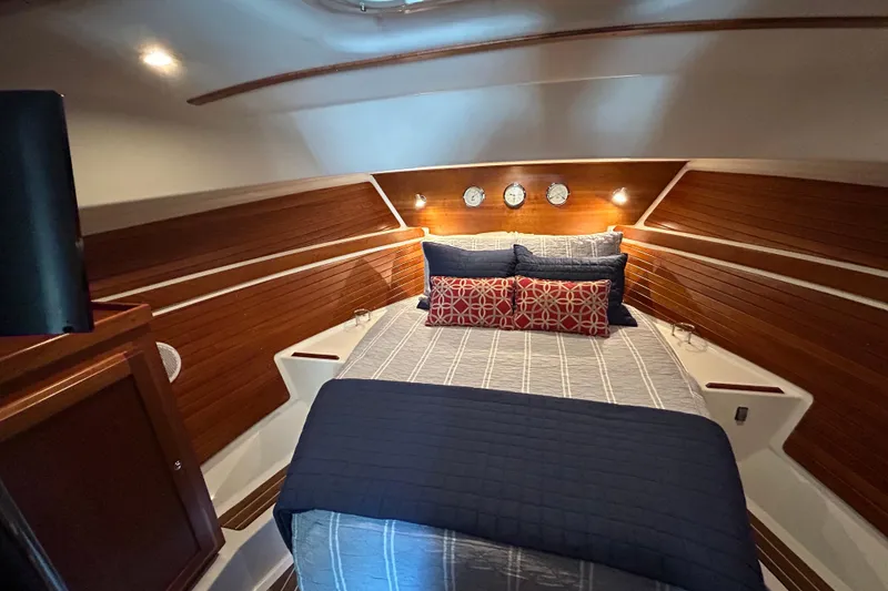 Slide: The Image of Cozy cabin interior of 2016 Back Cove 34 yacht with elegant wood paneling and plush bedding. - 60