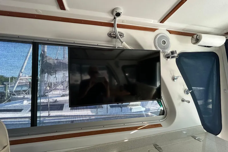Slide: The Image of Interior of a 2016 Back Cove 34 boat featuring a mounted TV and speaker system. - 38