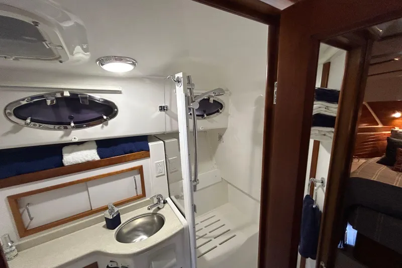 Slide: The Image of 2016 Back Cove 34 yacht bathroom with sink, shower, and storage. - 54