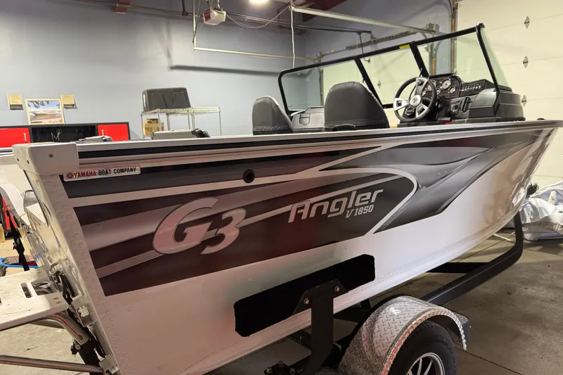 Slide: The Image of 2025 G3 Angler V1850 SF boat in a garage, showcasing sleek design and modern features. - 2